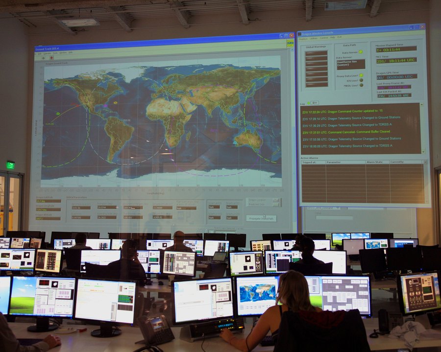 Mission control room with large world map displays